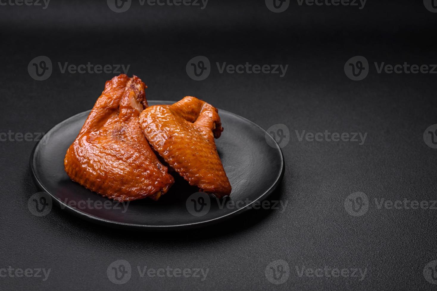 Delicious grilled chicken wings with spices and herbs photo