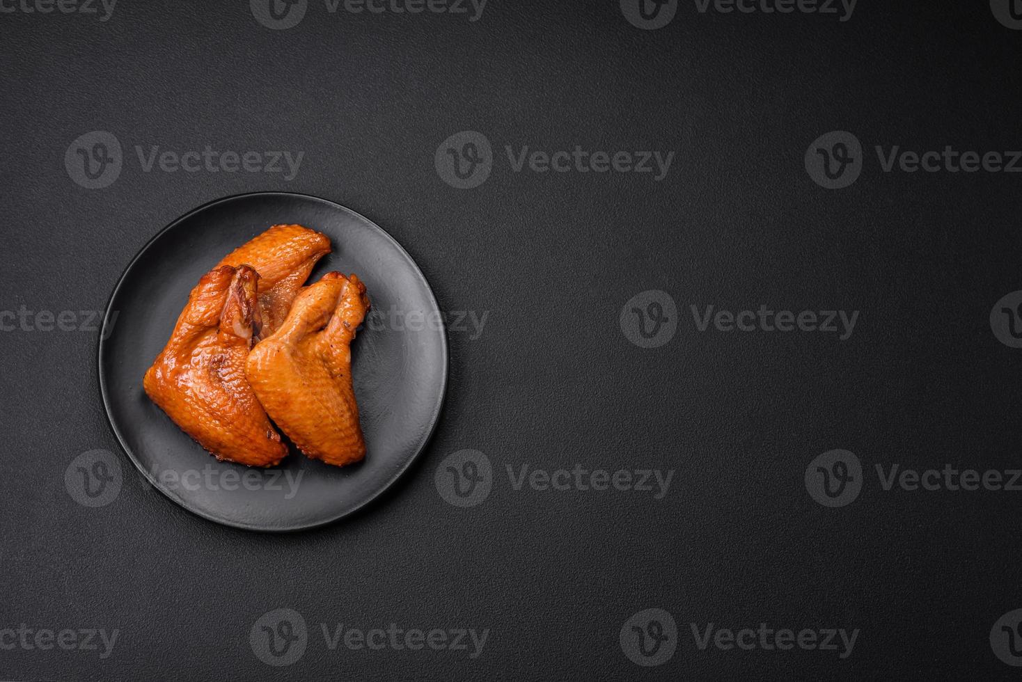 Delicious grilled chicken wings with spices and herbs photo