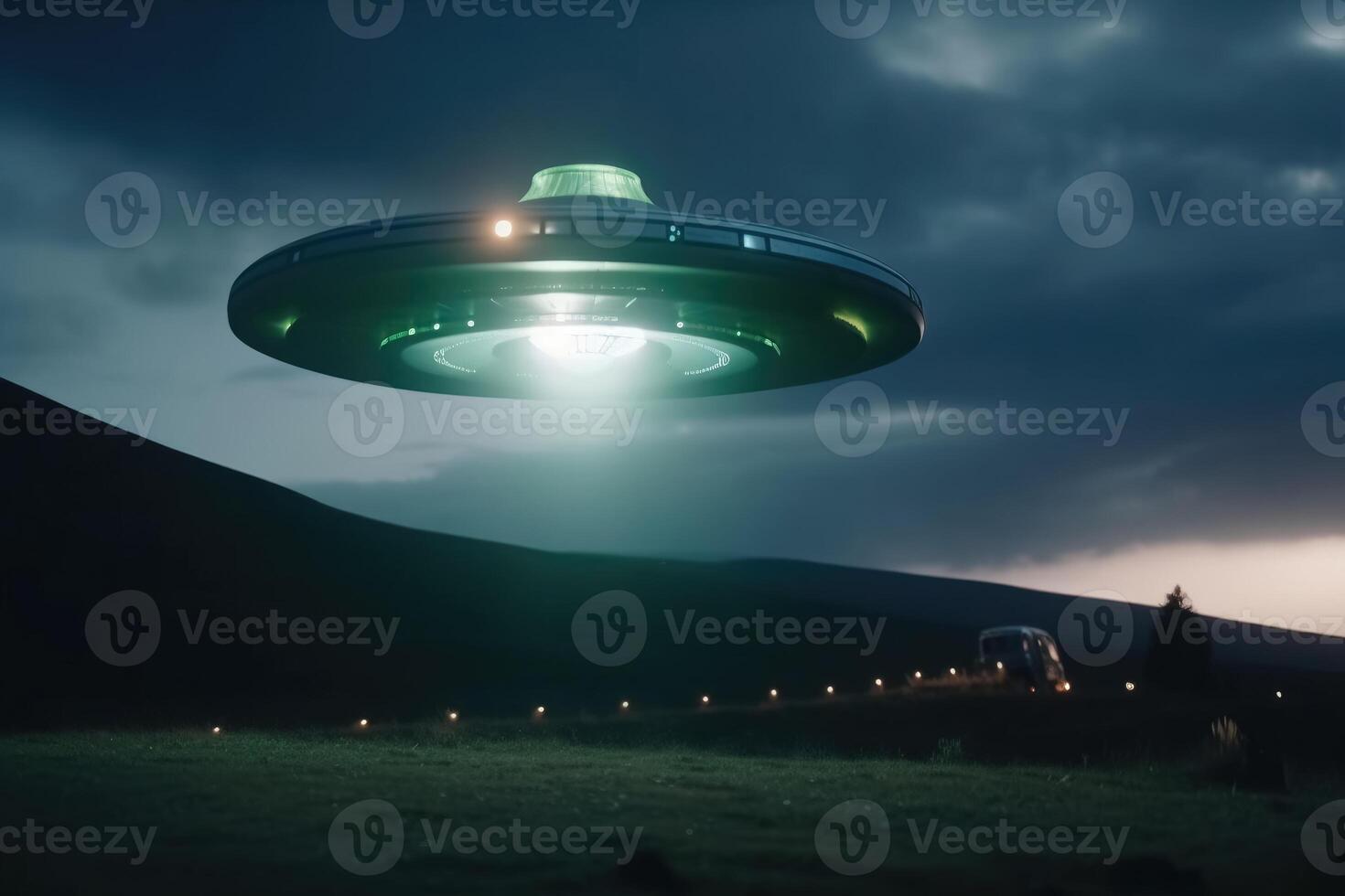 A close up view of a UFO with a spotlight pointed at the bottom of the landscape created with technology. photo
