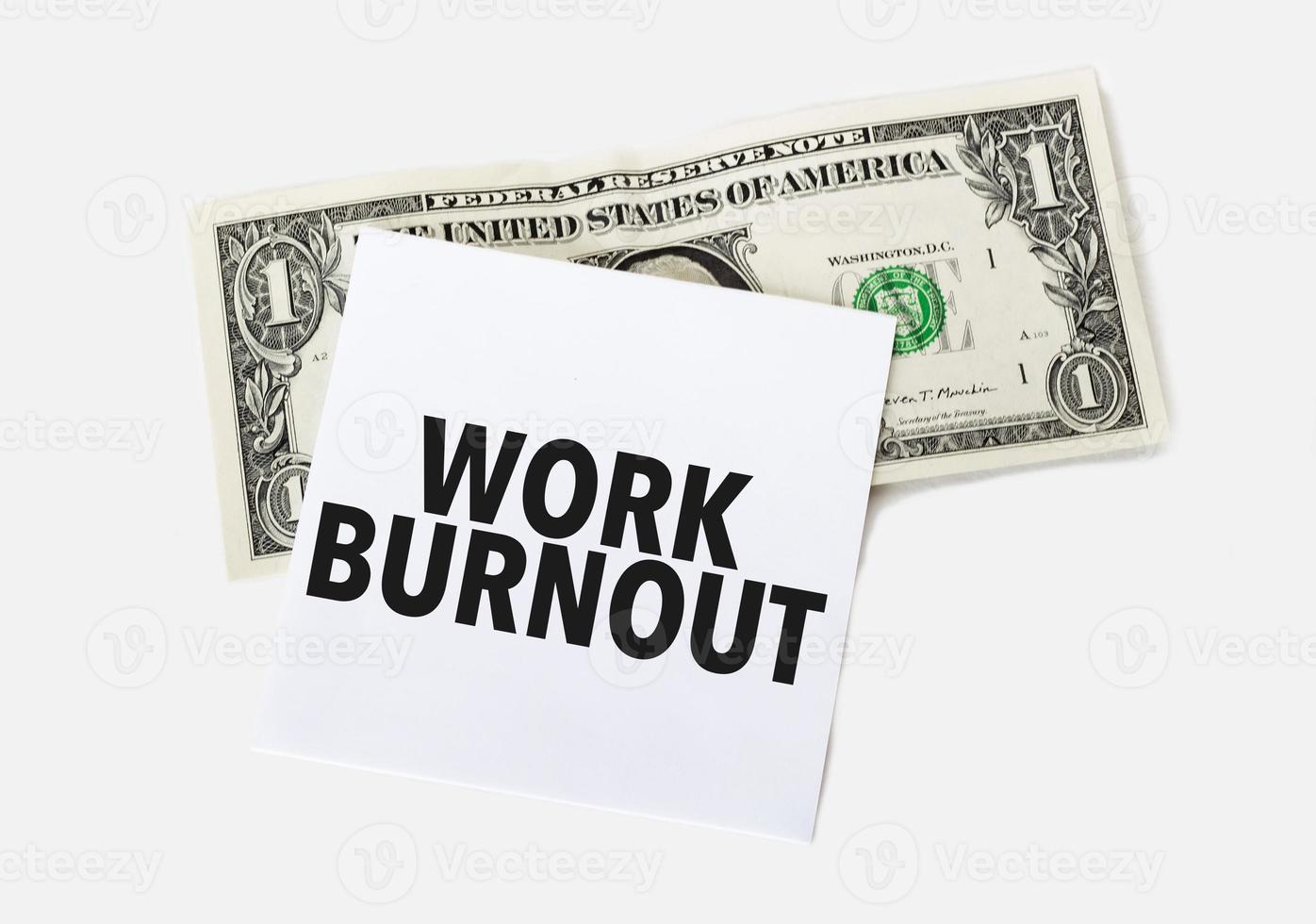 1 dollar bill and white notepad sheet on the white background. Text work burnout photo