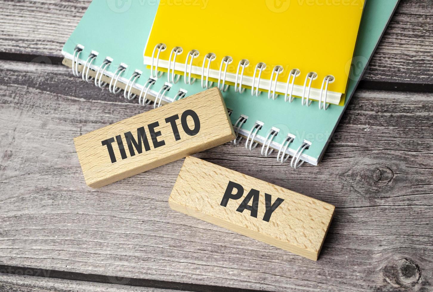 time to pay symbol. Concept words return on assets on wooden blocks. photo