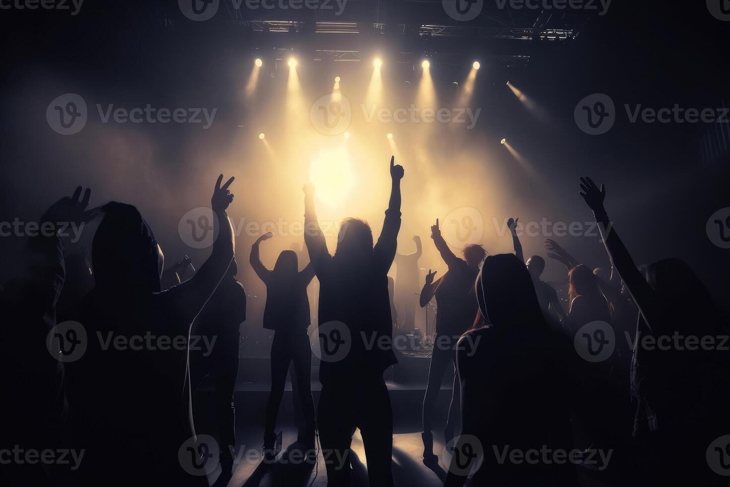 Black silhouette of a huge crowd of cheering people in front of a rock stage with soft bokeh lights created with technology. photo