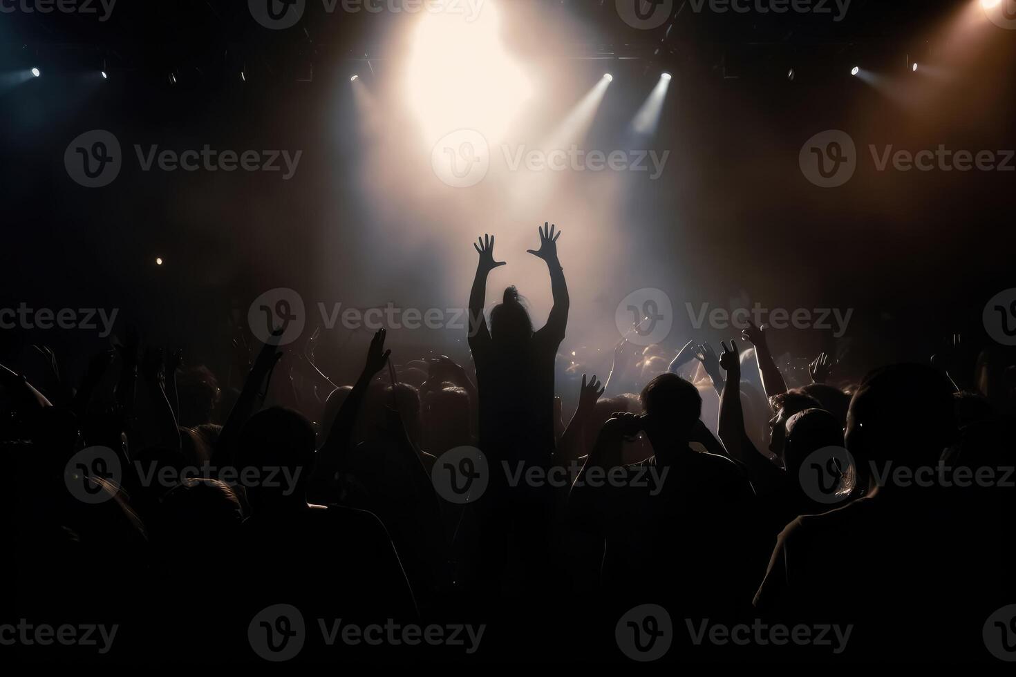 Black silhouette of a huge crowd of cheering people in front of a rock stage with soft bokeh lights created with technology. photo