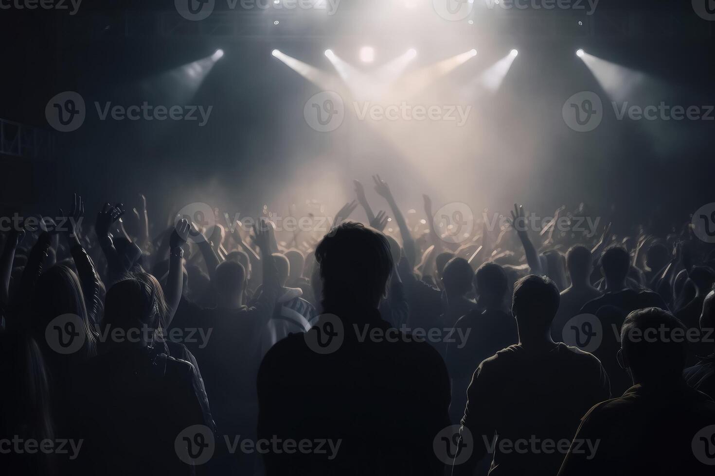 Black silhouette of a huge crowd of cheering people in front of a rock stage with soft bokeh lights created with technology. photo