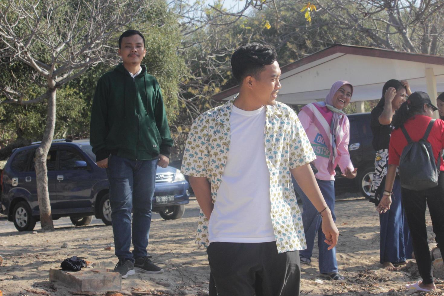 Atambua, Nusa Tenggara Timur, 2023 Tourists standing on white sand beaches exposed to sunlight photo