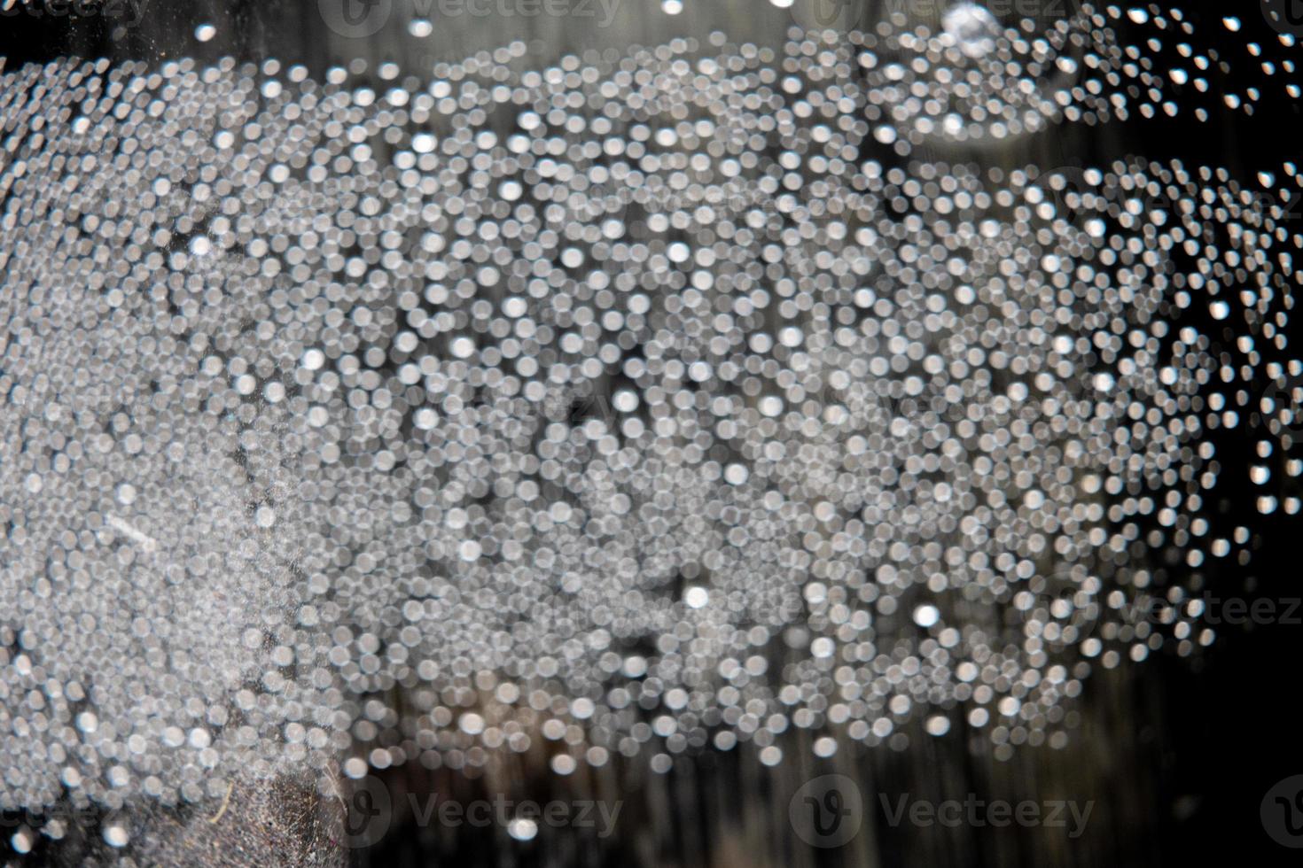 out of focus water drops in closeup creating bokeh background photo