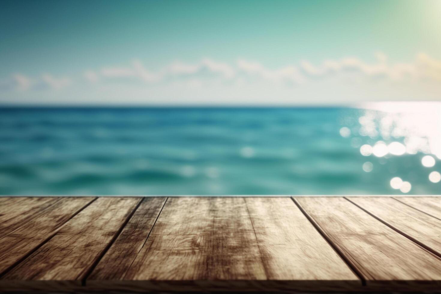An Empty wooden table top with a blurred view of the ocean landscape in the background, photo