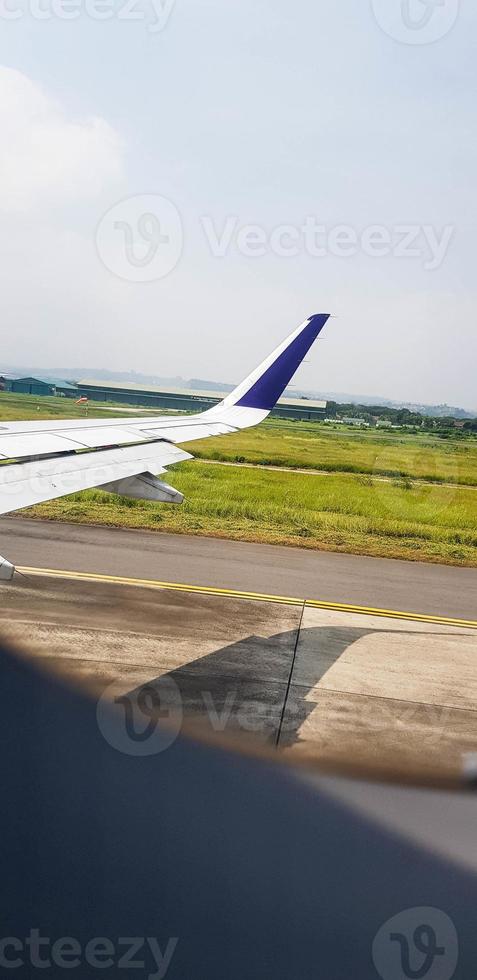 view from airplane window on the wing when departure. photo