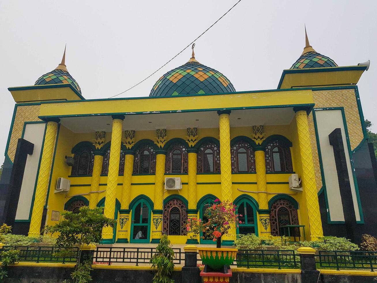 Riau, Indonesia in October 2019. A mosque near the Indrapura Siak Palace, dominated by yellow and green lines and has carved Siak ornaments. photo