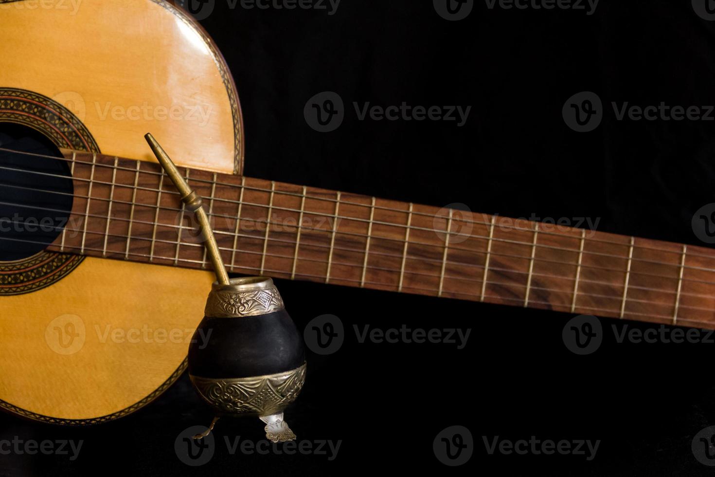 Mate and guitar, concept of Argentine folklore, isolated on black background photo