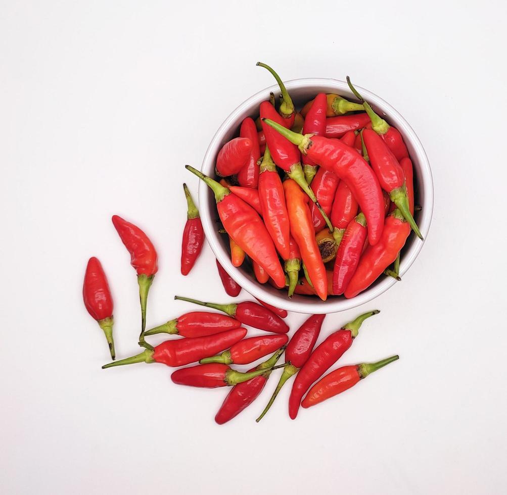 Chili peppers or Cayenne pepper or Cabe rawit in a bowl isolated on white background. photo