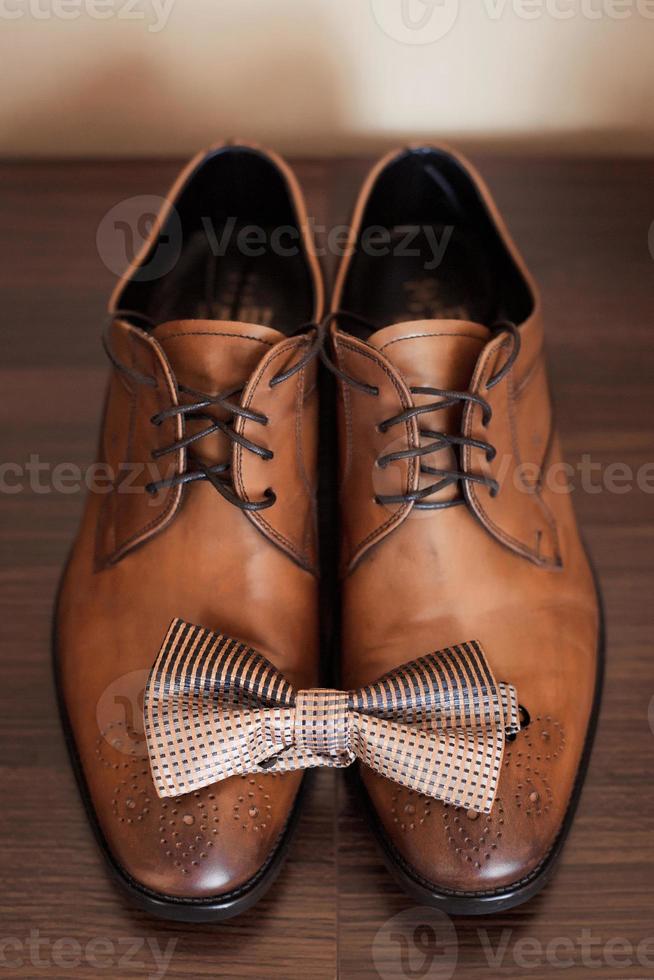 Mans brown leather shoes with bow tie for evening event photo