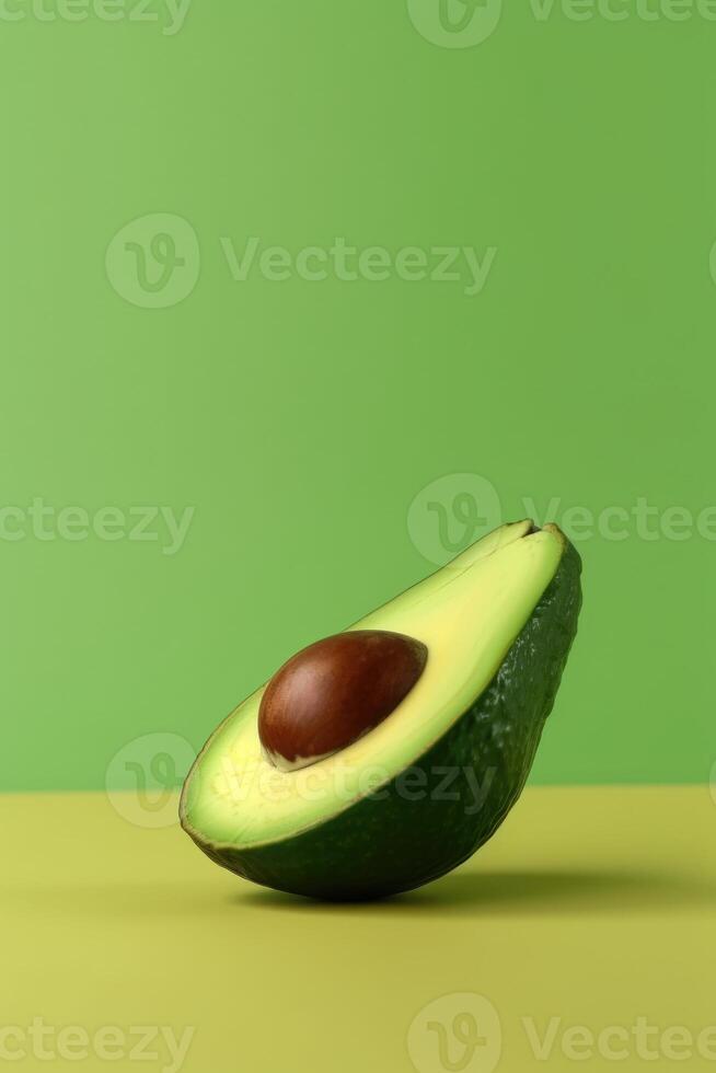 A half of avocado on color block yellow and green background. . photo