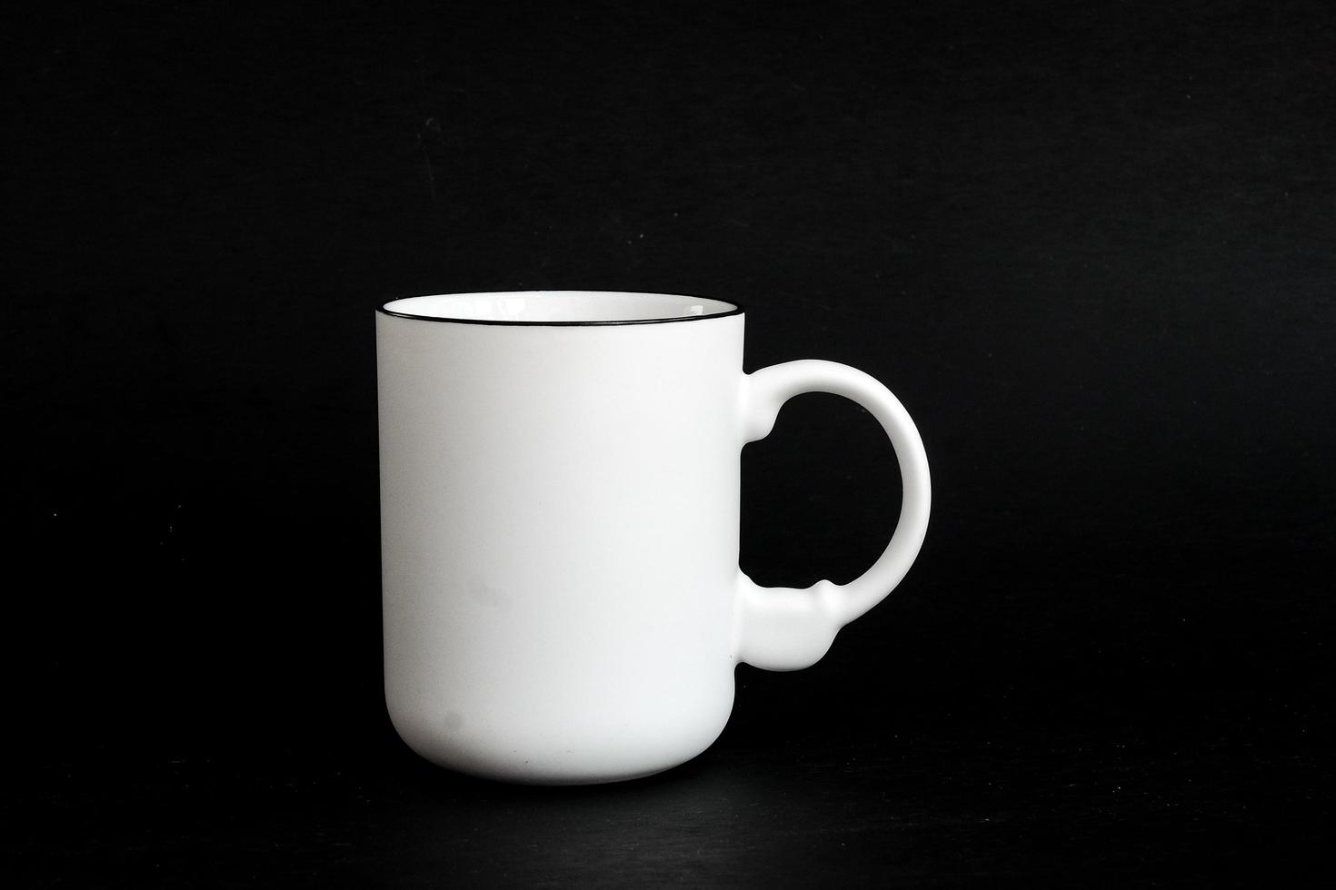 White mug. White cup with red heart for tea or coffee on background. photo