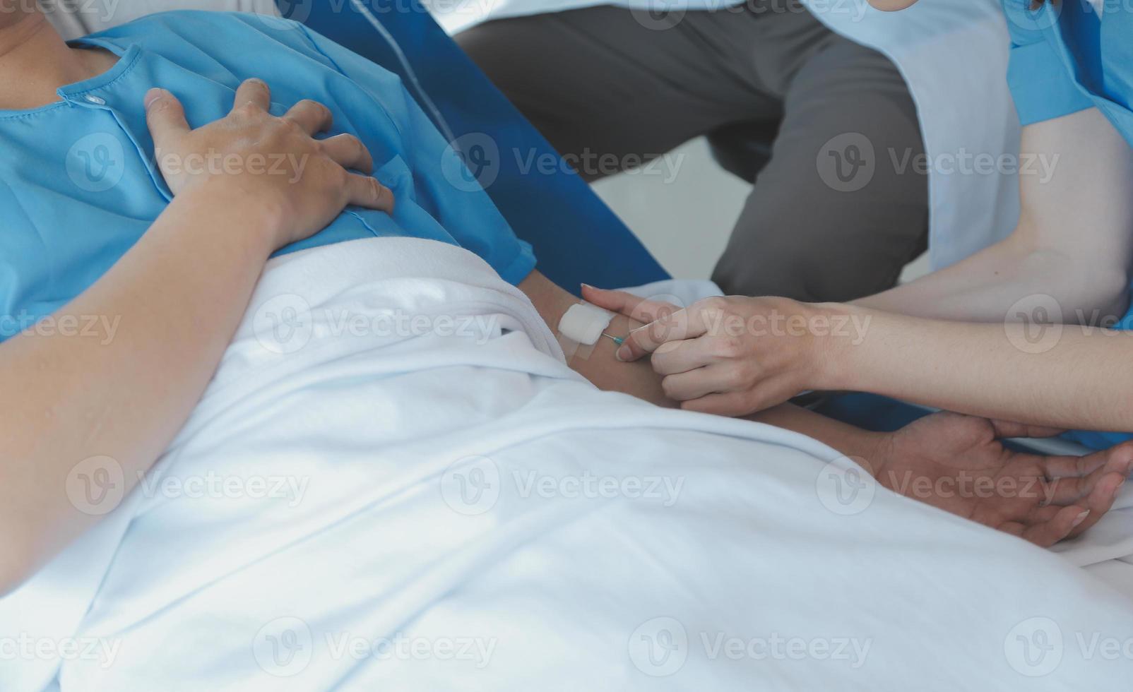 Women Asian doctors hold the patient hand and encourage and provide medical advice While checking the patient health in bed. Concept of Care and compassion, antenatal care, Threatened abortion photo