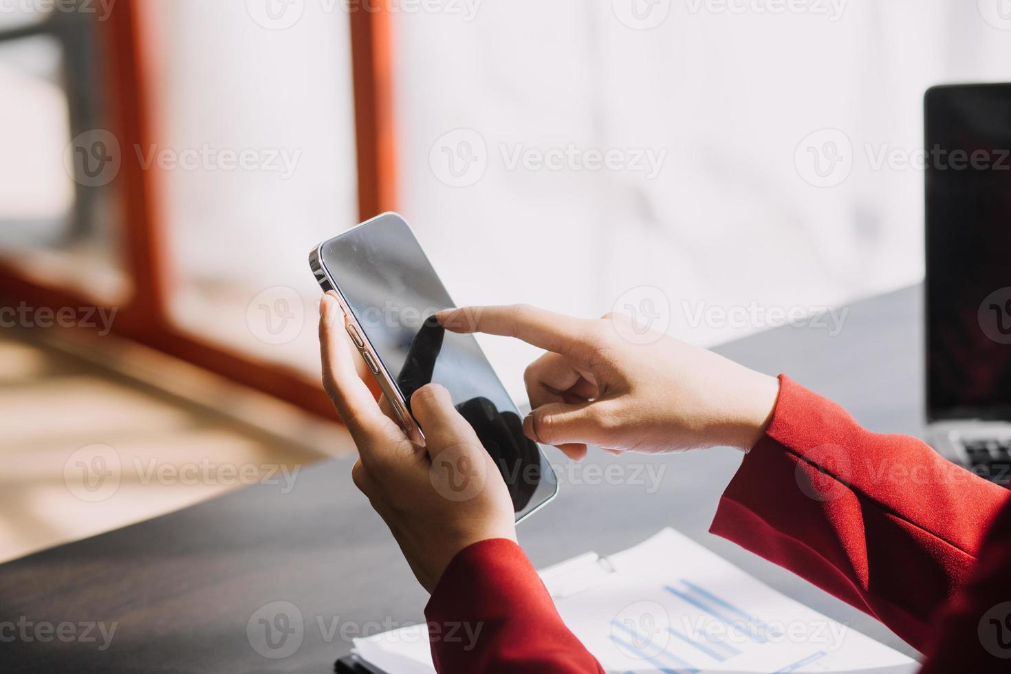 Asian Business woman using calculator and laptop for doing math finance on an office desk, tax, report, accounting, statistics, and analytical research concept photo