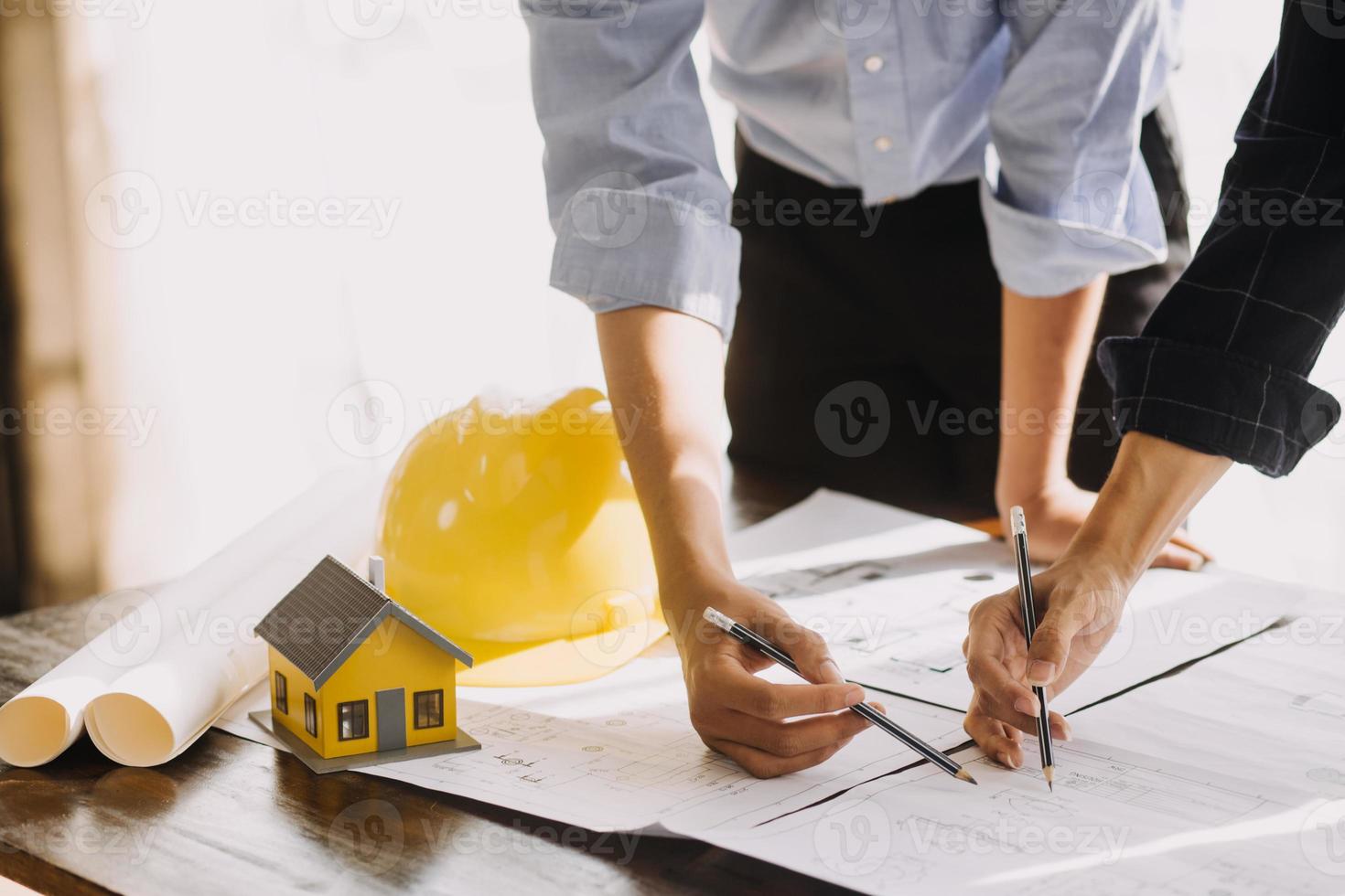 Two business man construction site engineer. Engineering objects on workplace with partners interacting on background photo
