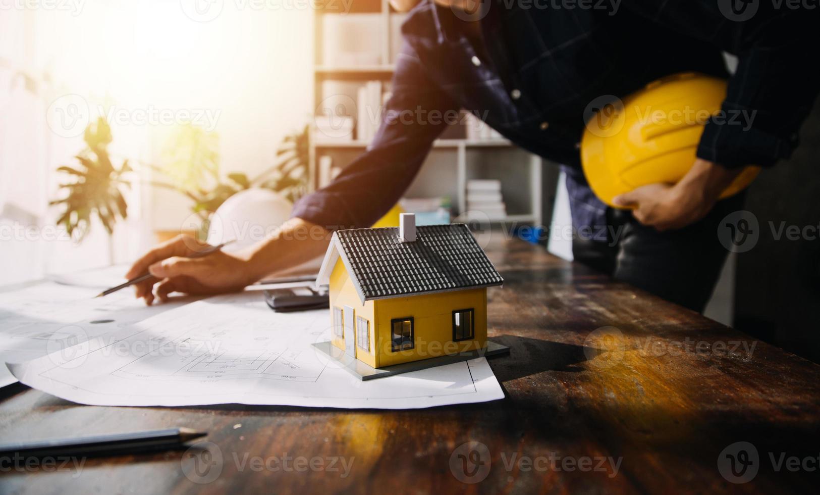 Two business man construction site engineer. Engineering objects on workplace with partners interacting on background photo
