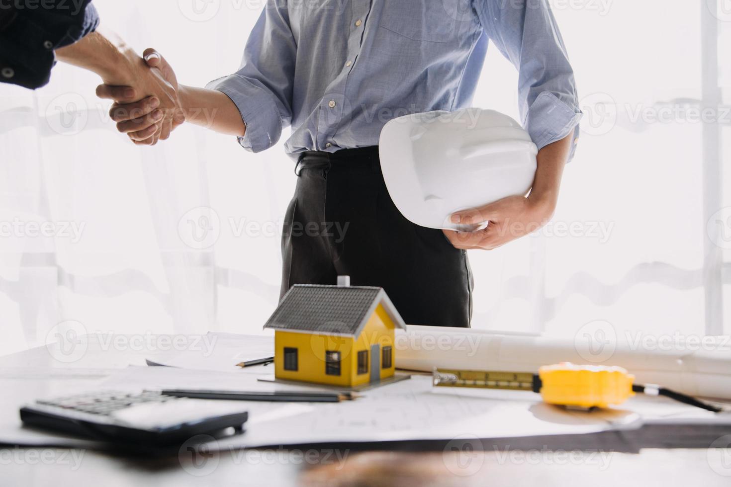 Two business man construction site engineer. Engineering objects on workplace with partners interacting on background photo