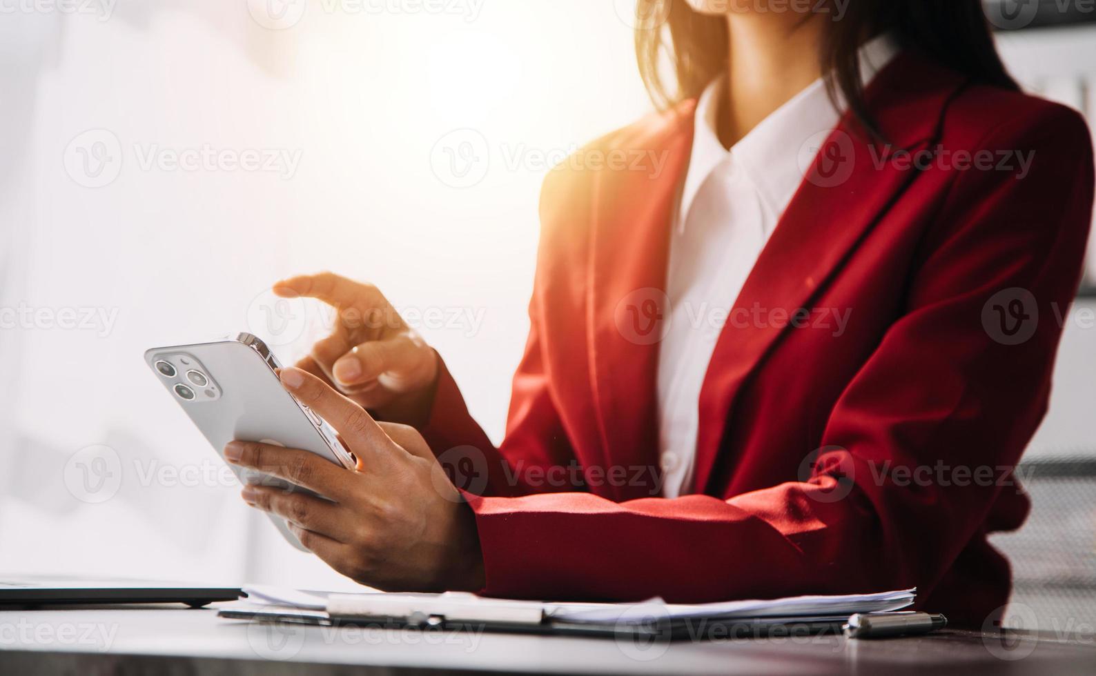 Asian Business woman using calculator and laptop for doing math finance on an office desk, tax, report, accounting, statistics, and analytical research concept photo