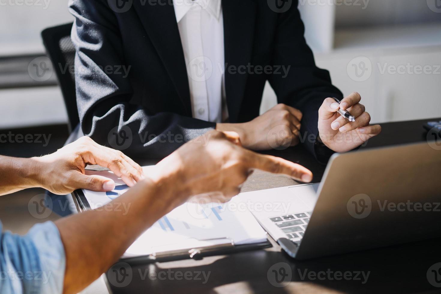 Asian Business woman using calculator and laptop for doing math finance on an office desk, tax, report, accounting, statistics, and analytical research concept photo