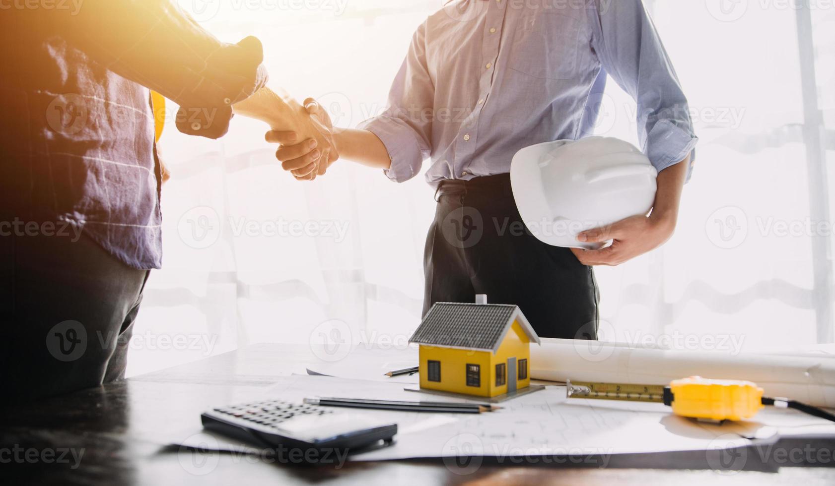 Two business man construction site engineer. Engineering objects on workplace with partners interacting on background photo