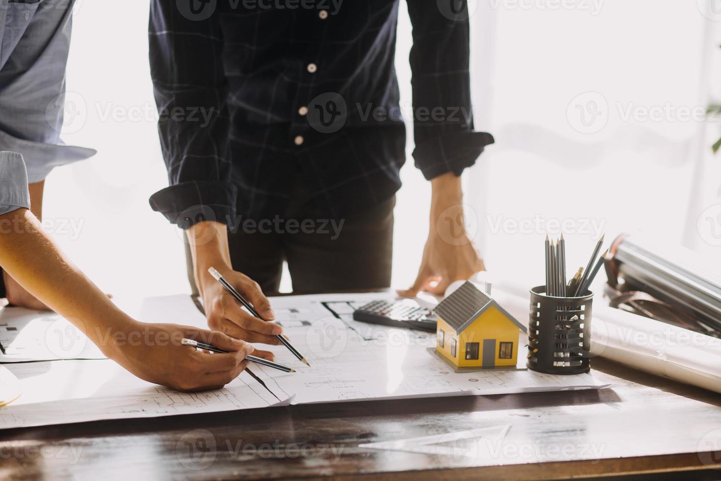 Two business man construction site engineer. Engineering objects on workplace with partners interacting on background photo