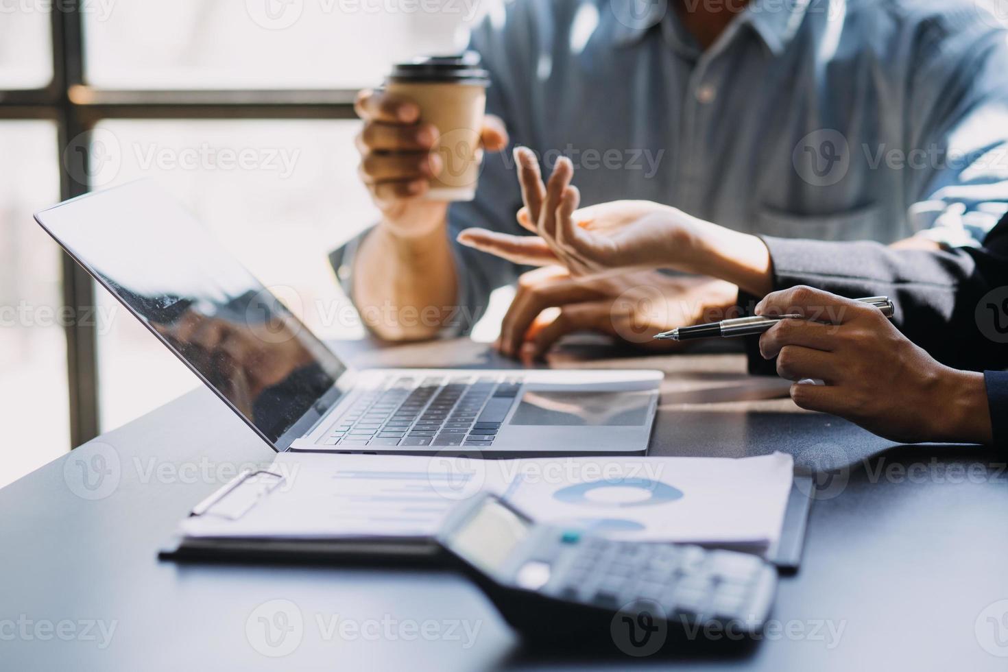 Asian Business woman using calculator and laptop for doing math finance on an office desk, tax, report, accounting, statistics, and analytical research concept photo