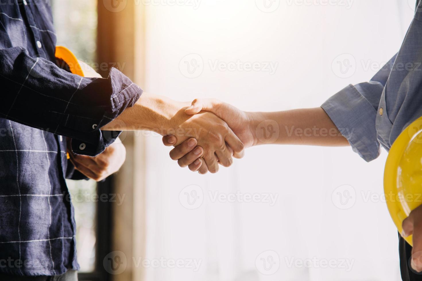 Two business man construction site engineer. Engineering objects on workplace with partners interacting on background photo