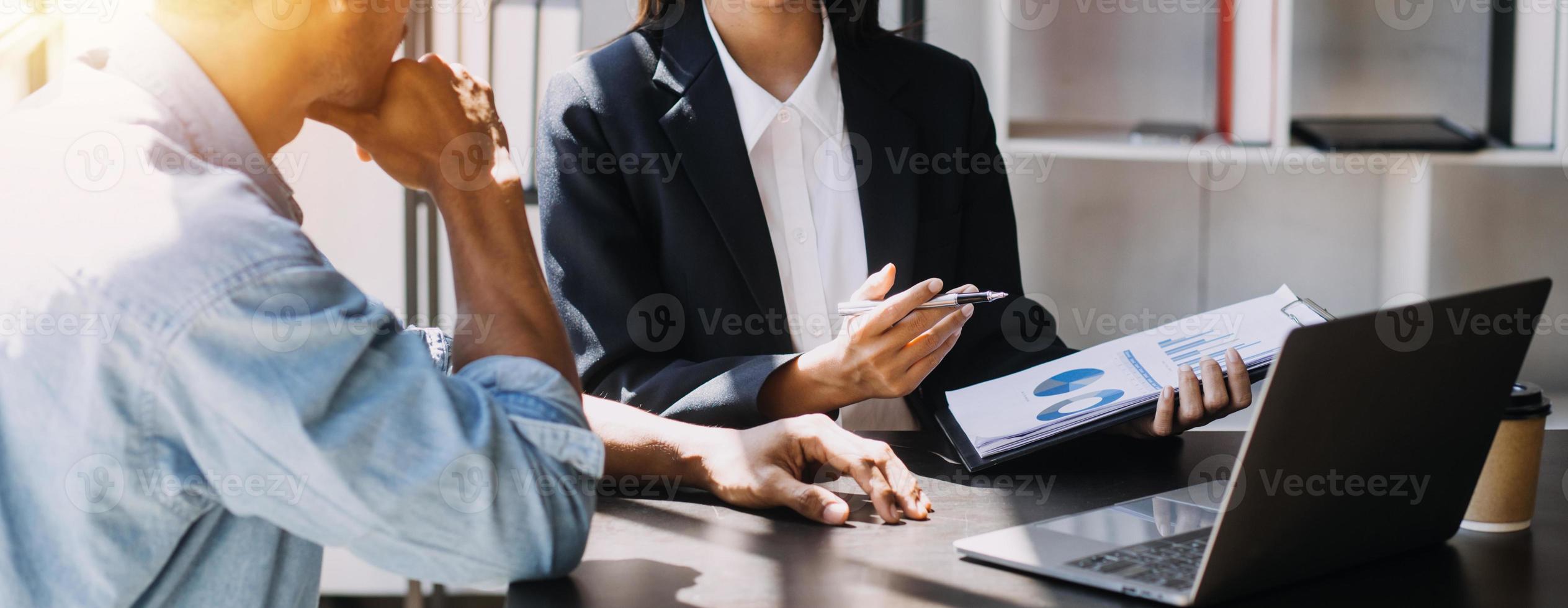 Asian Business woman using calculator and laptop for doing math finance on an office desk, tax, report, accounting, statistics, and analytical research concept photo