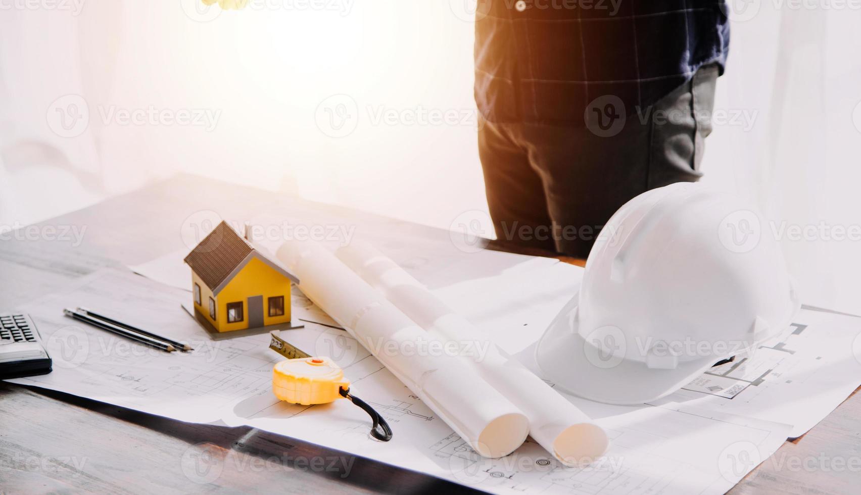 Two business man construction site engineer. Engineering objects on workplace with partners interacting on background photo