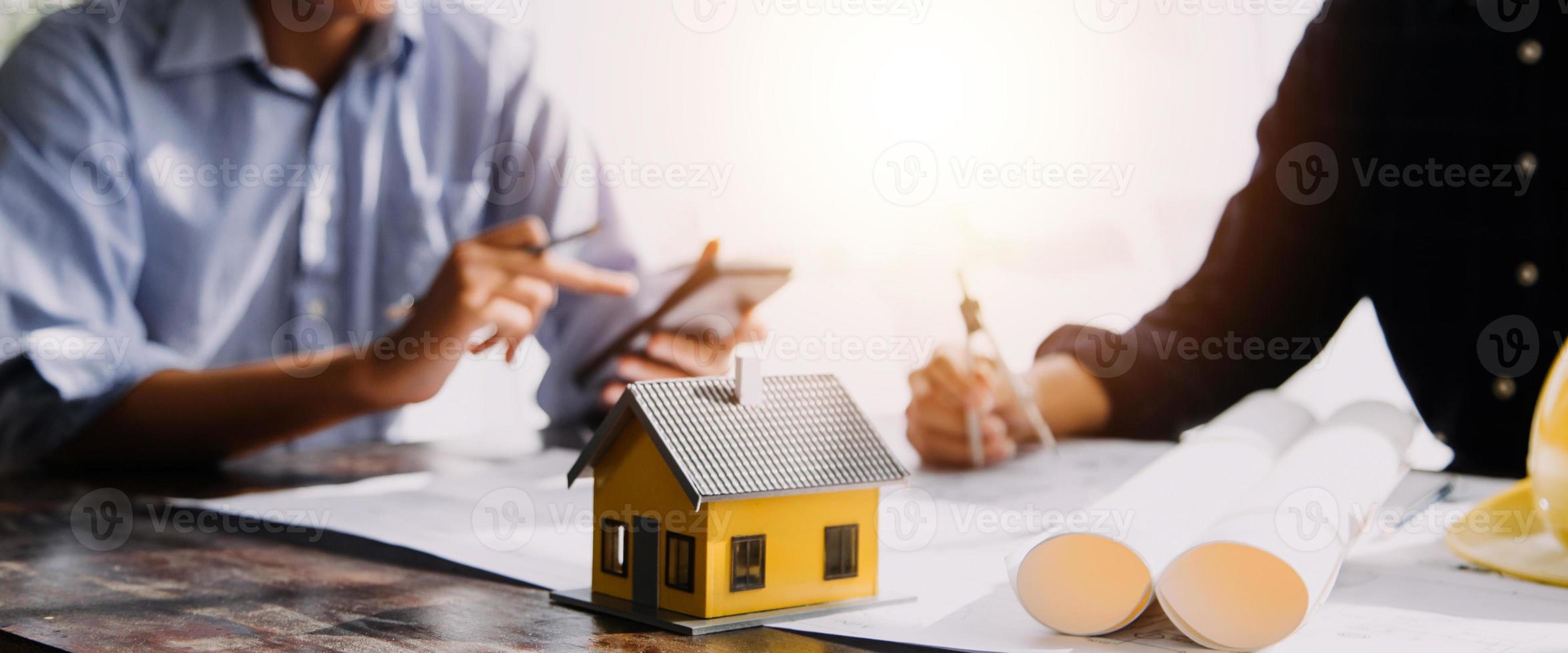 Two business man construction site engineer. Engineering objects on workplace with partners interacting on background photo