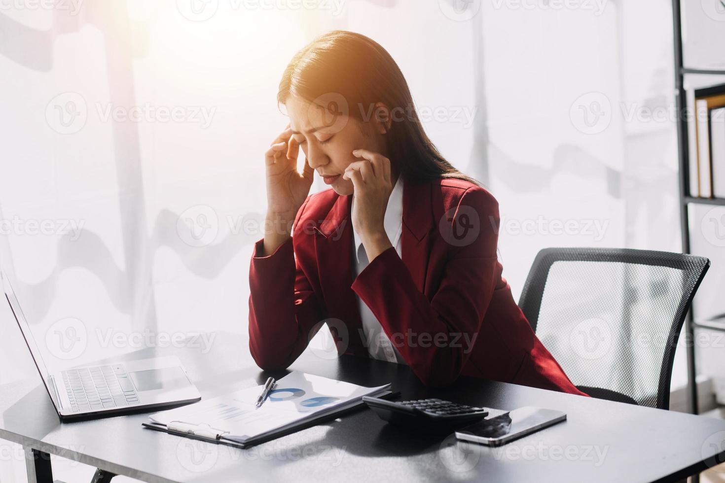 Asian women are stressed while working on laptop, Tired asian businesswoman with headache at office, feeling sick at work, copy space photo