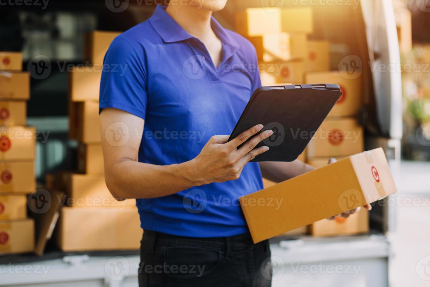 Parcel boxes on shelf and color shopping bags placing near laptop on table. SME business on shopping online at home office packaging on background is popular business. photo