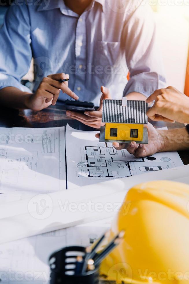 Two business man construction site engineer. Engineering objects on workplace with partners interacting on background photo
