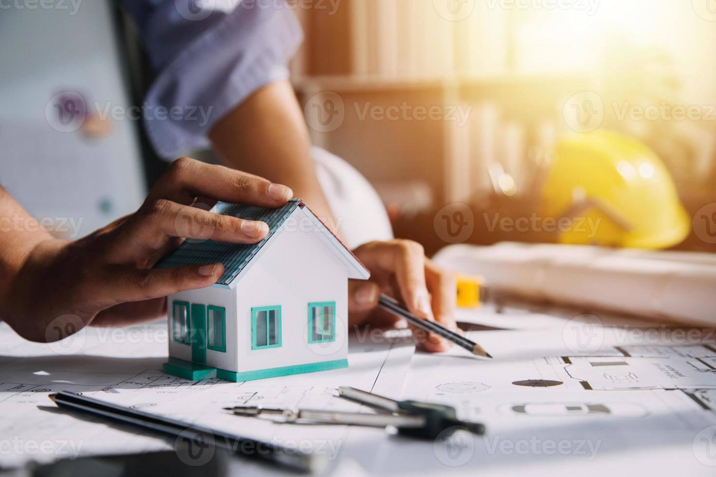Two business man construction site engineer. Engineering objects on workplace with partners interacting on background photo