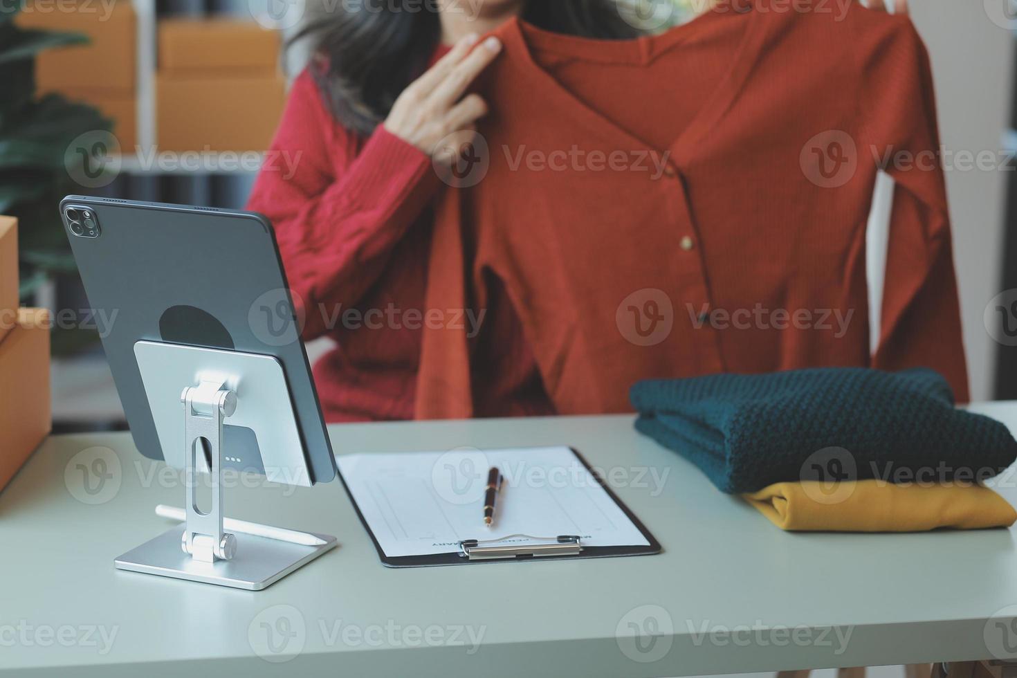 Entrepreneurs Small Business SME Independent men work at home Use smartphones and laptops for commercial checking, online marketing, packing boxes, SME sellers, concept, e-commerce team, online sales photo