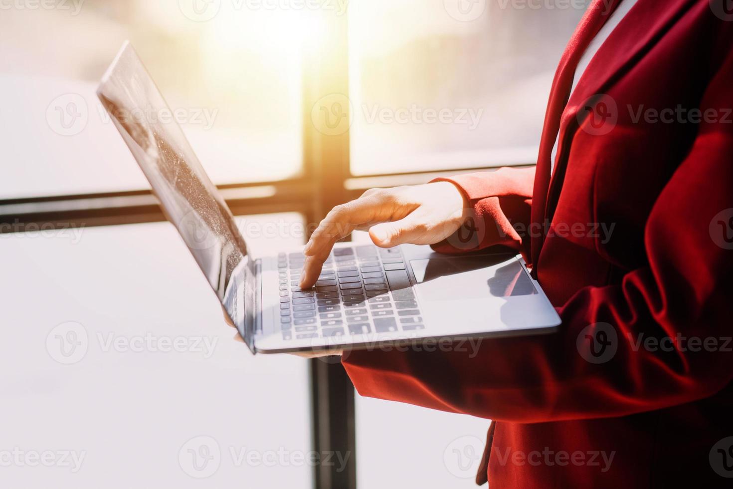 Asian Business woman using calculator and laptop for doing math finance on an office desk, tax, report, accounting, statistics, and analytical research concept photo
