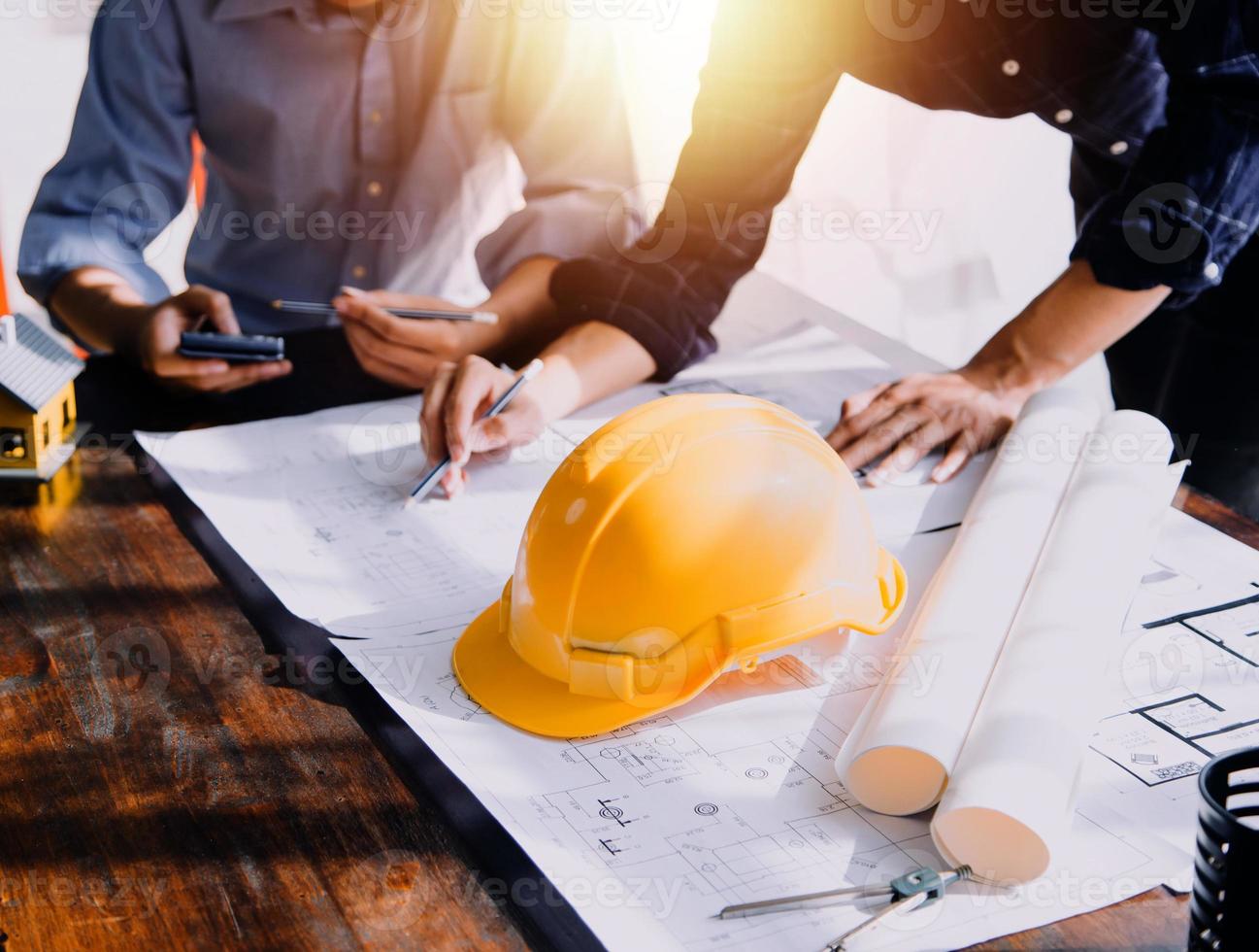 Two business man construction site engineer. Engineering objects on workplace with partners interacting on background photo