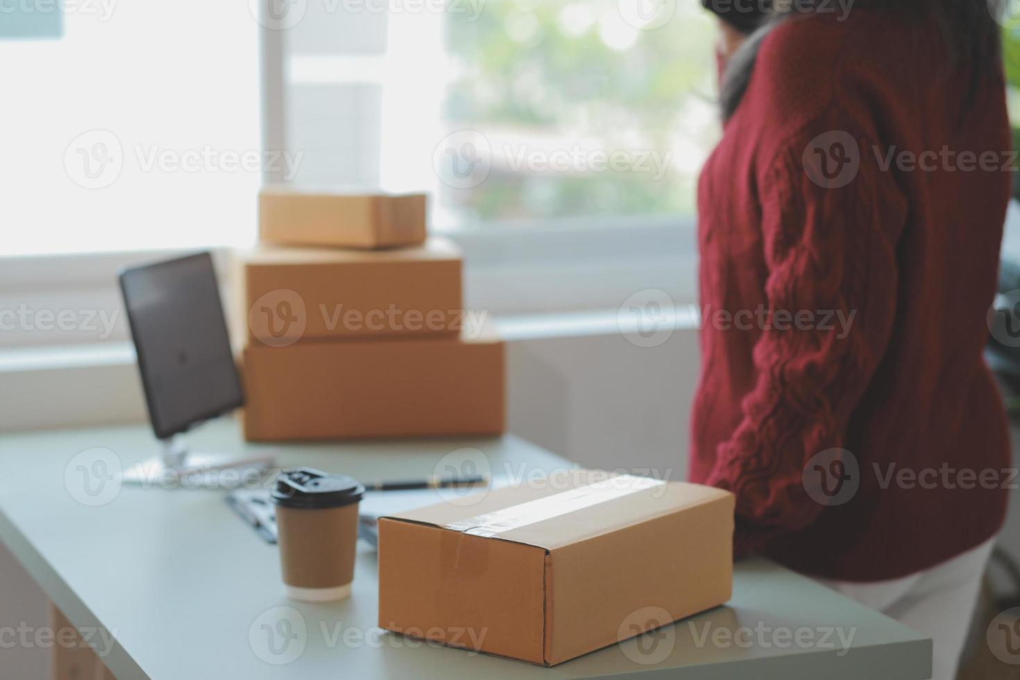 Entrepreneurs Small Business SME Independent men work at home Use smartphones and laptops for commercial checking, online marketing, packing boxes, SME sellers, concept, e-commerce team, online sales photo