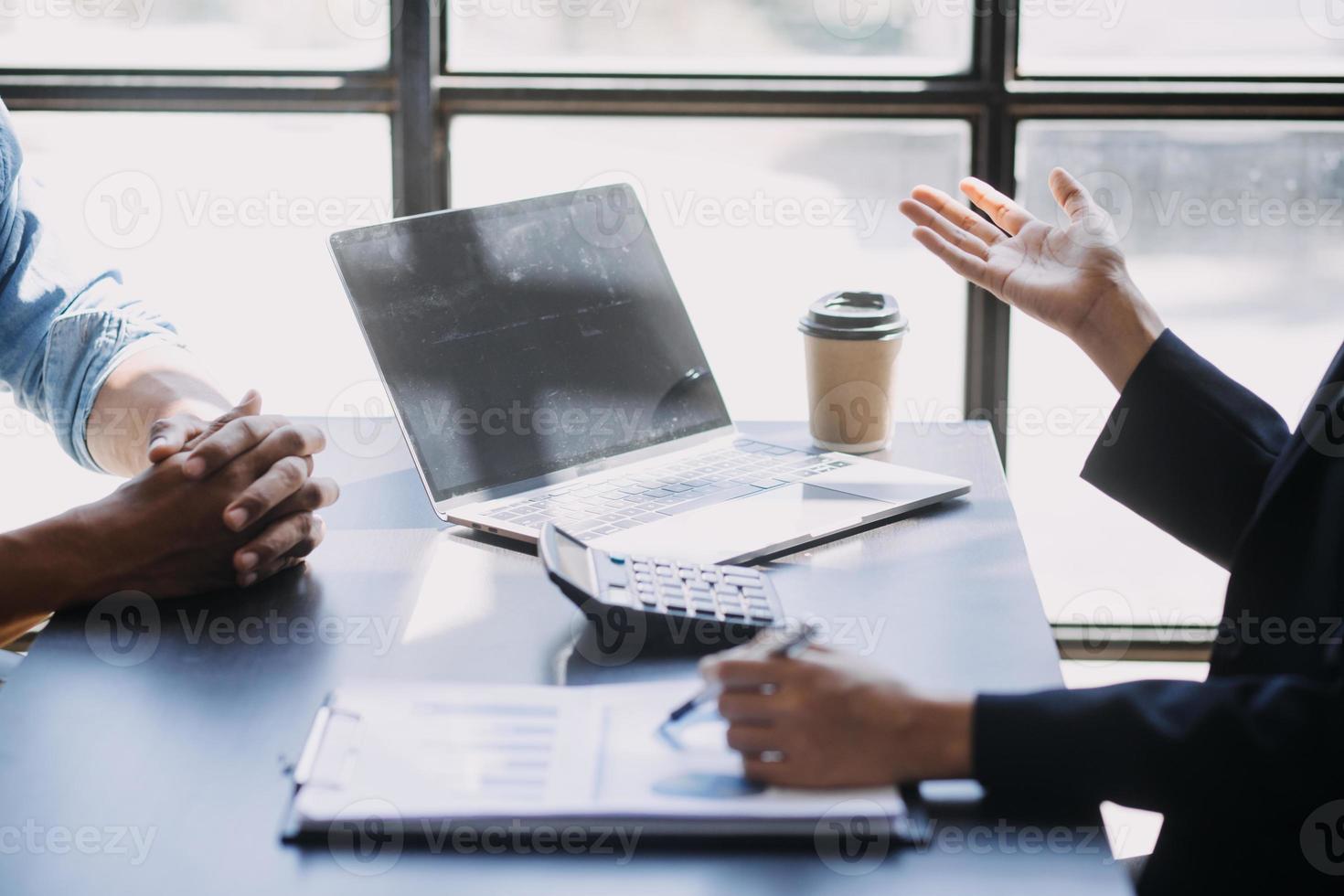 Asian Business woman using calculator and laptop for doing math finance on an office desk, tax, report, accounting, statistics, and analytical research concept photo