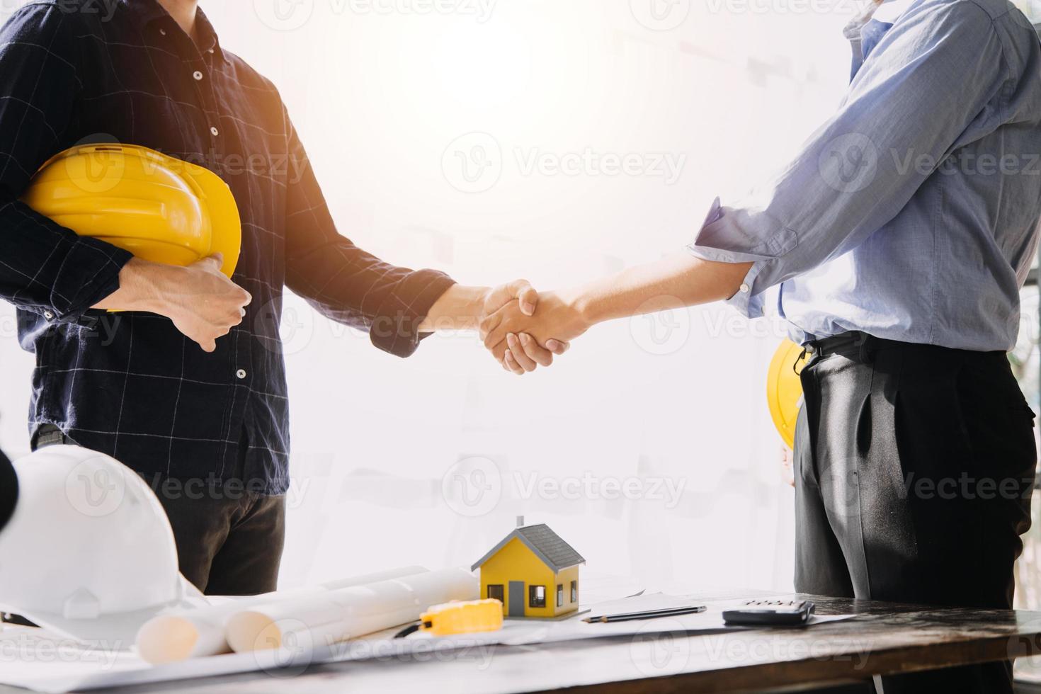 Two business man construction site engineer. Engineering objects on workplace with partners interacting on background photo