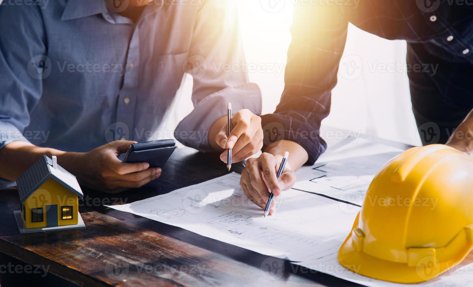Two business man construction site engineer. Engineering objects on workplace with partners interacting on background photo