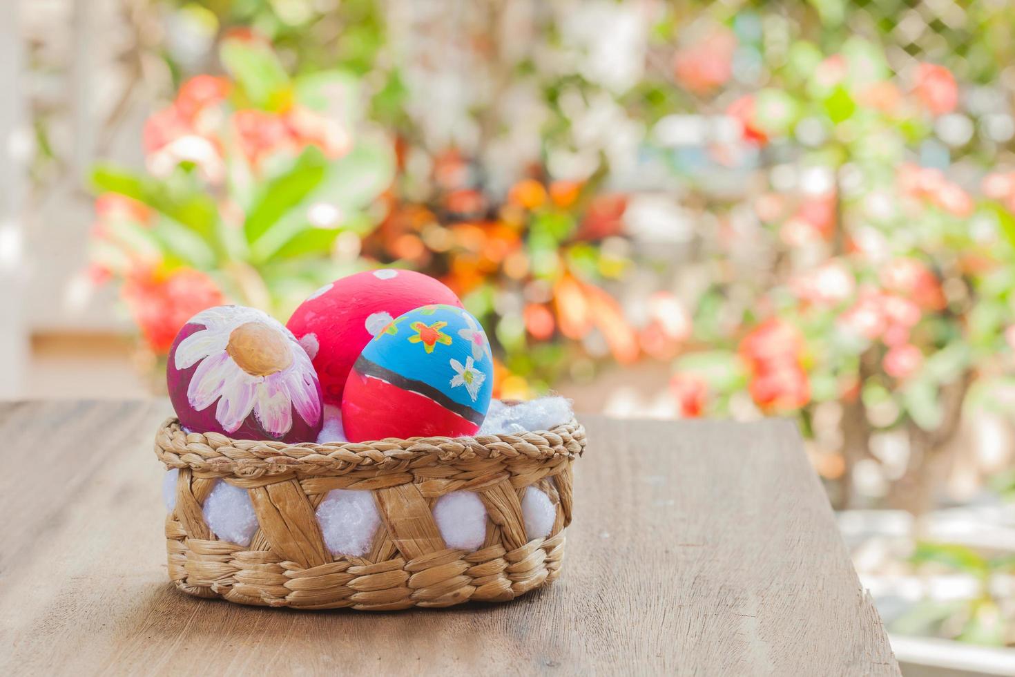 easter egg in basket on wood photo