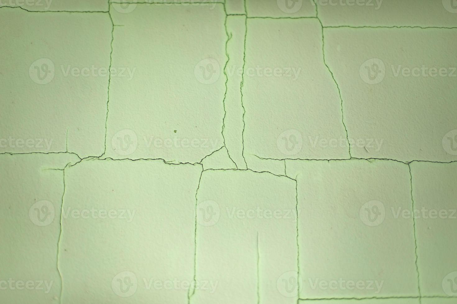 Cracks on wall. Scratches on green background. Old paint. photo