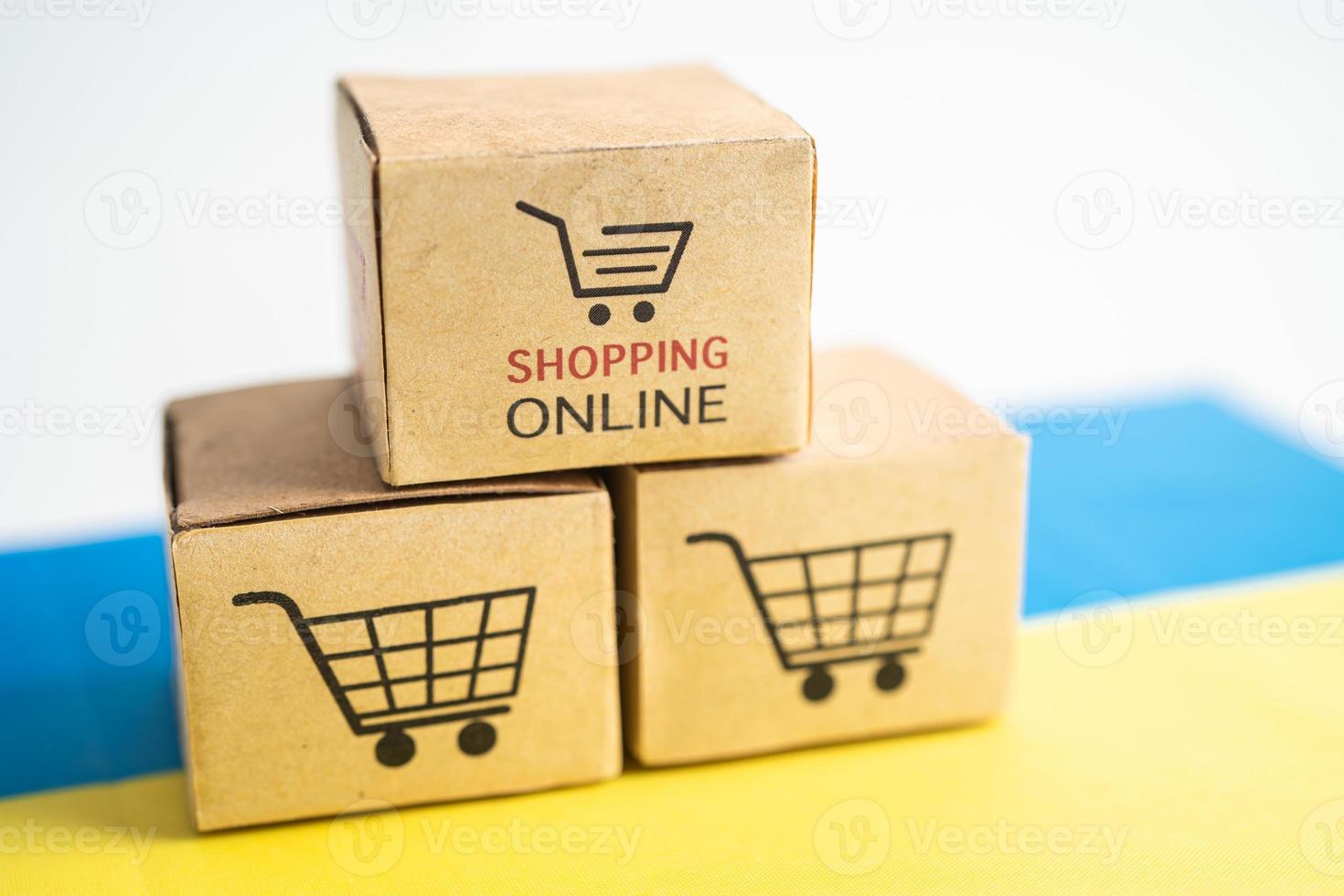 Box with shopping online cart logo and Ukraine flag, Import Export Shopping online or commerce finance delivery service store product shipping, trade, supplier concept. photo