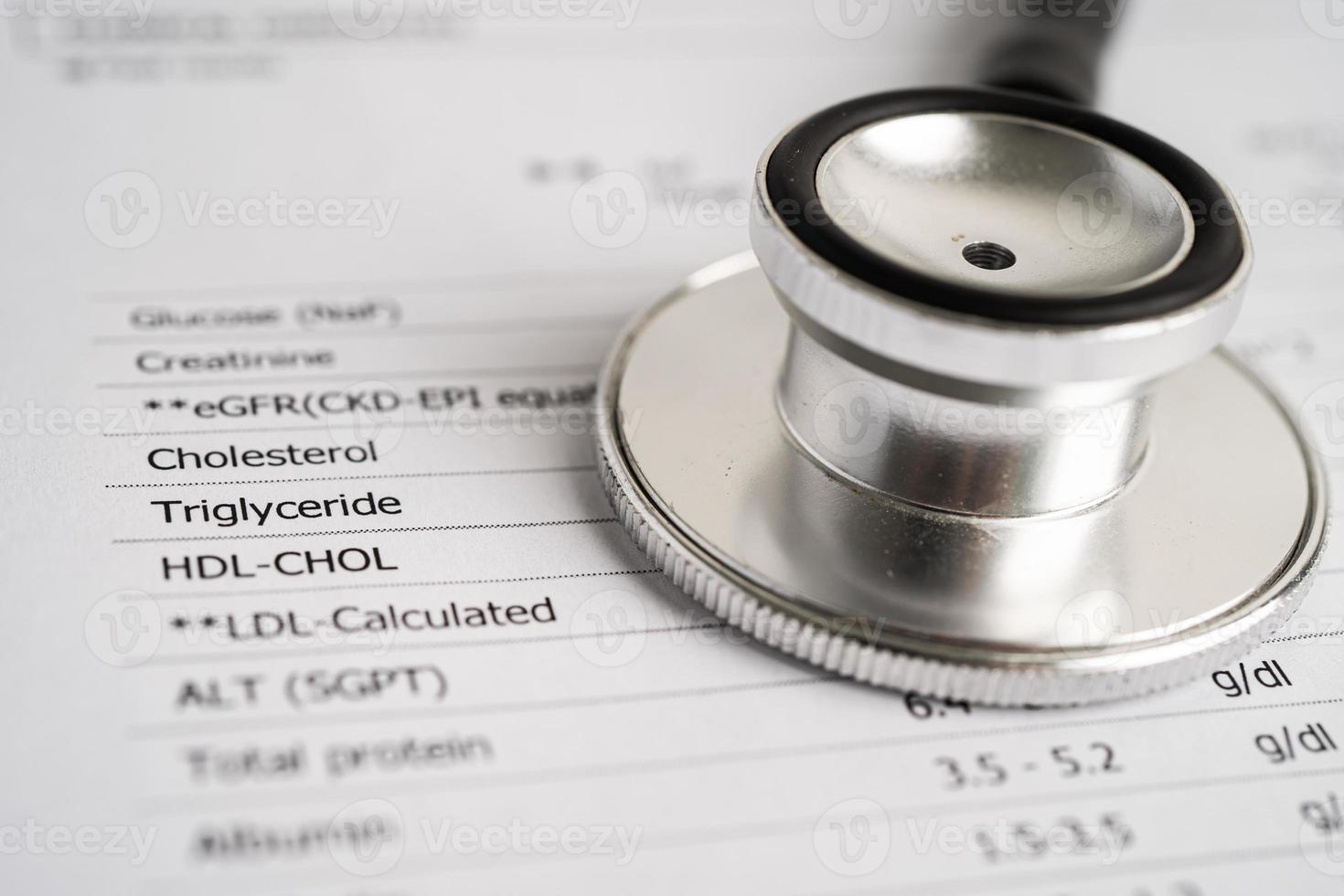 Stethoscope on blood test report, egfr, cholesterol, triglyceride, hdl, ldl. photo