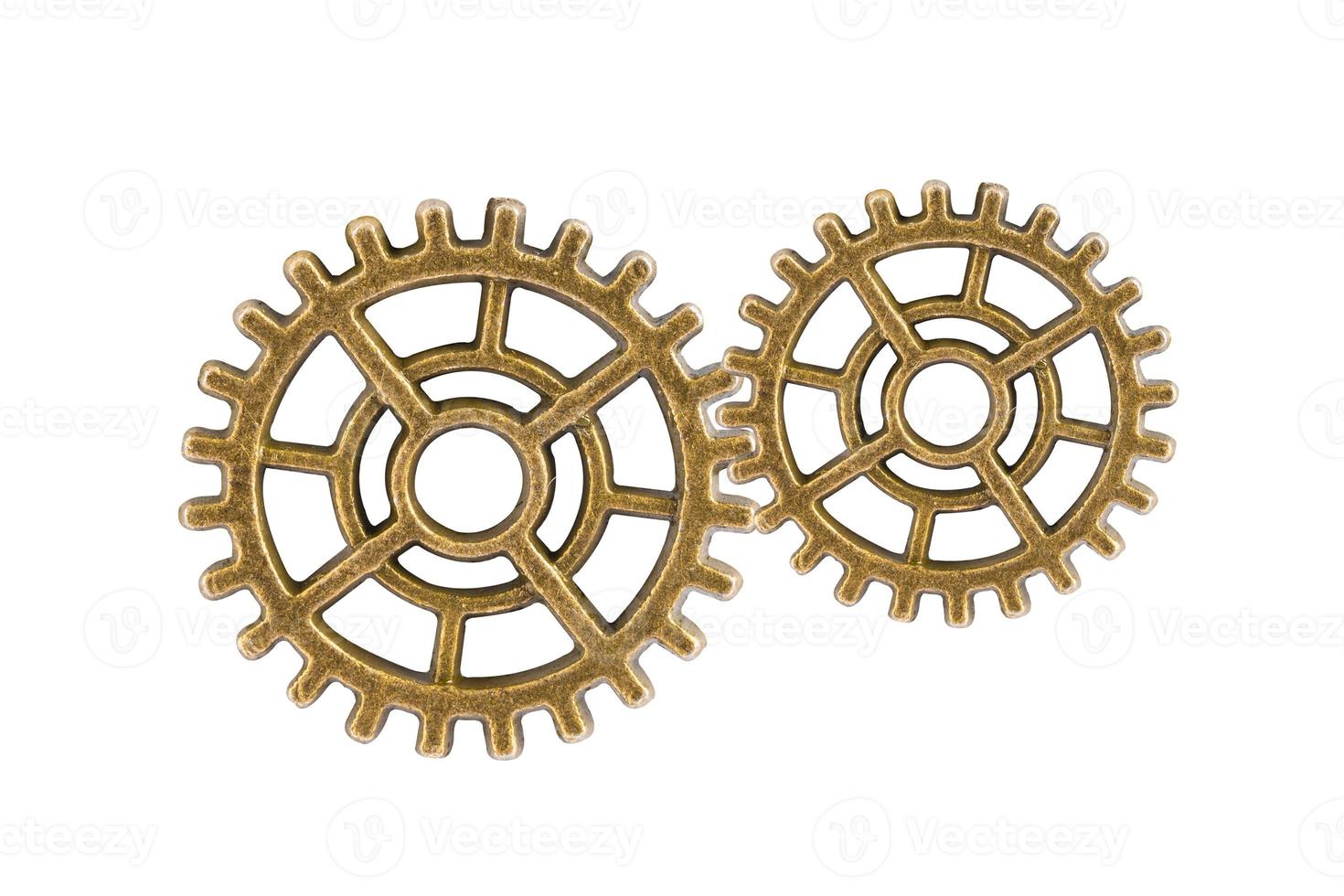 Gear and cogs wheels isolated on a white background, clock mechanism, brass metal engine industrial. photo