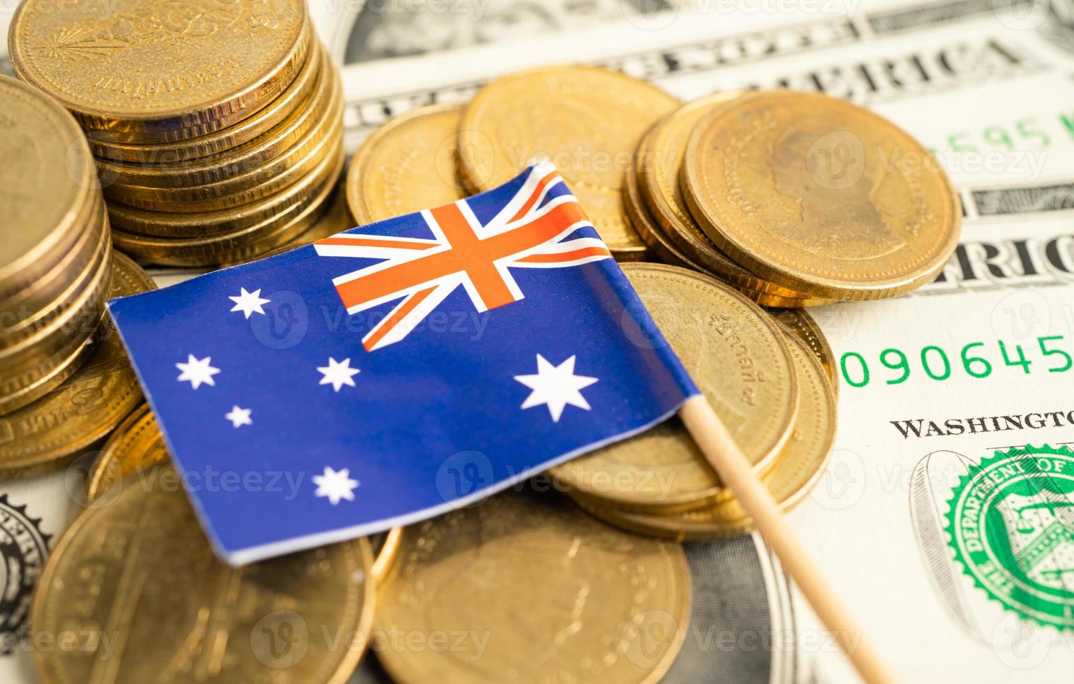 Stack of coins with Australia flag and US dollar banknotes. photo