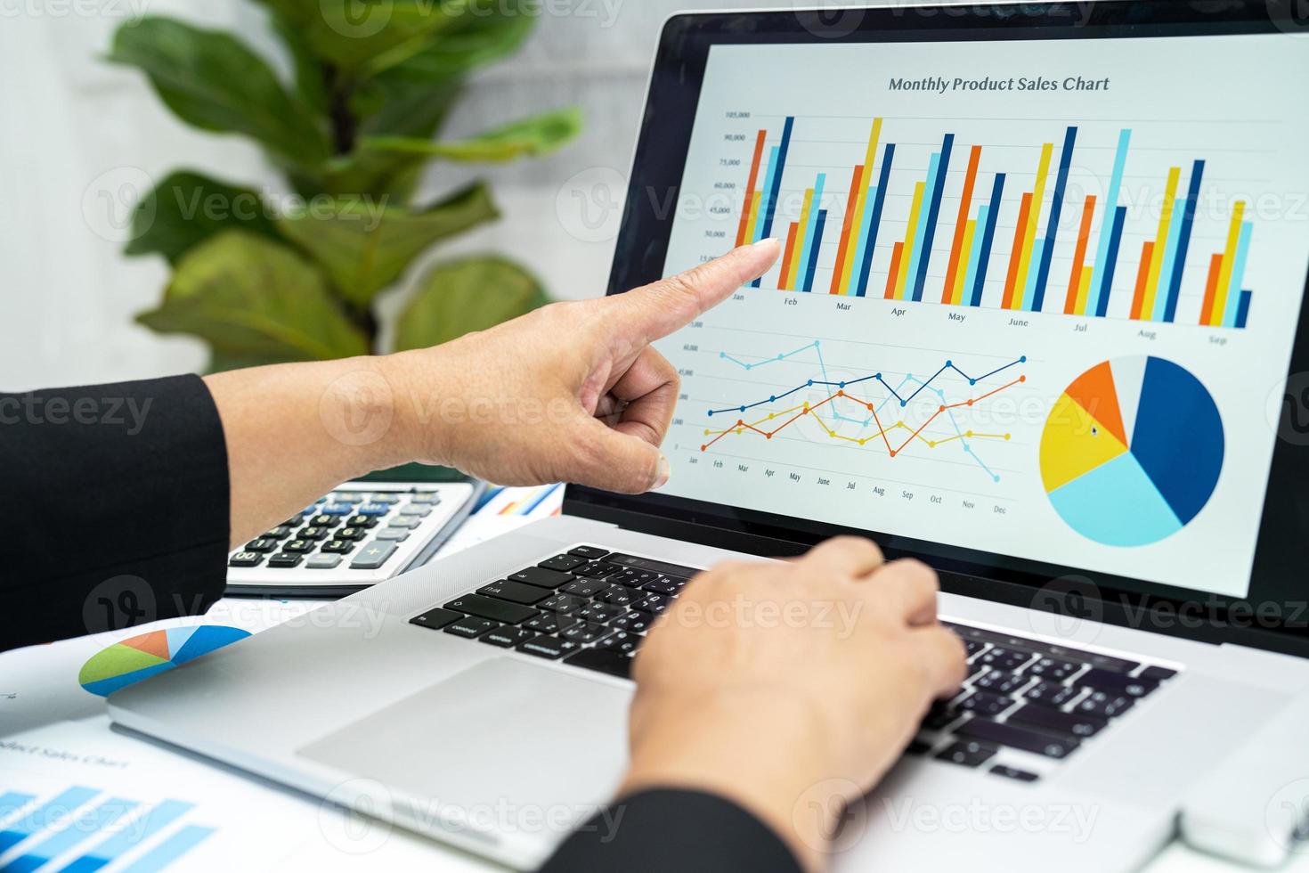 Asian accountant working and analyzing financial reports project accounting with chart graph in modern office, finance and business concept. photo